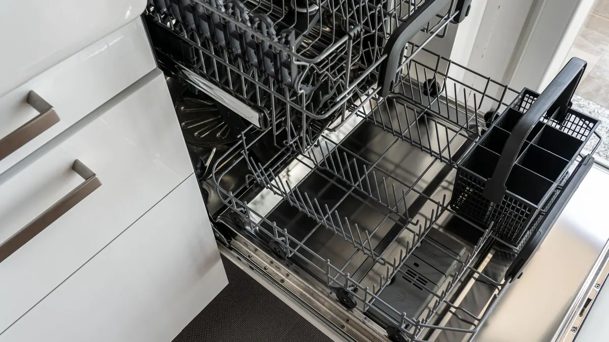 Open dishwasher with empty racks