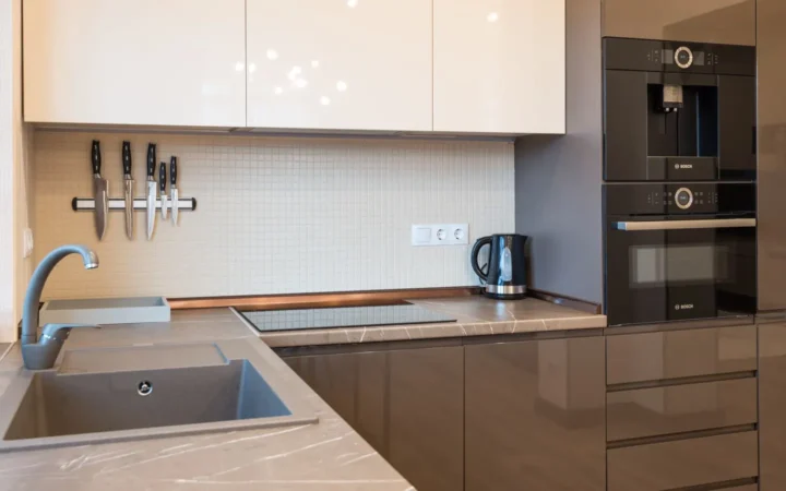 Modern kitchen with built-in oven and stainless appliances