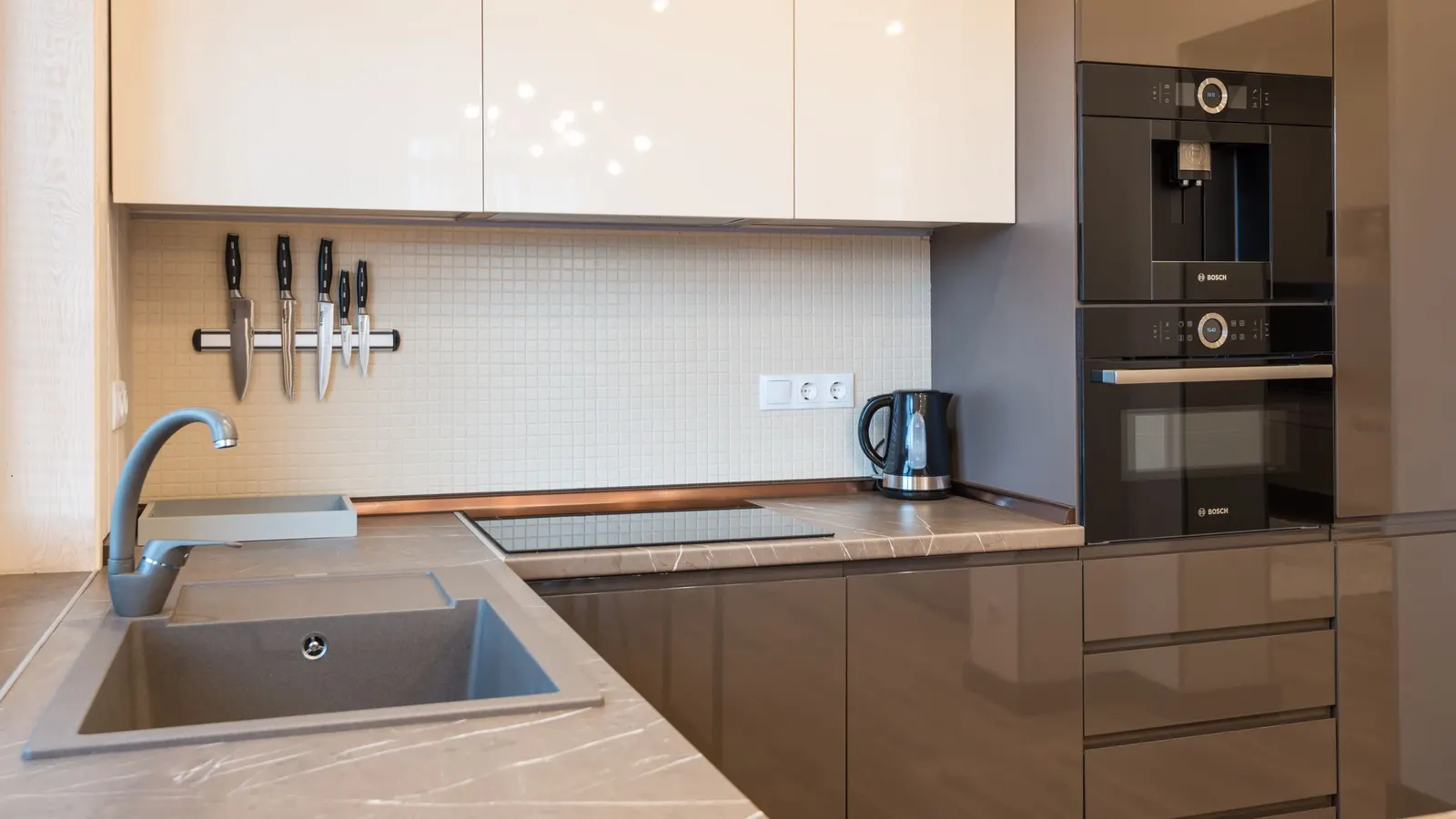 Modern kitchen with built-in oven and stainless appliances