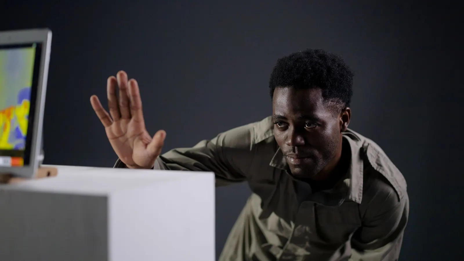 Man pointing at a thermal heat map on a screen