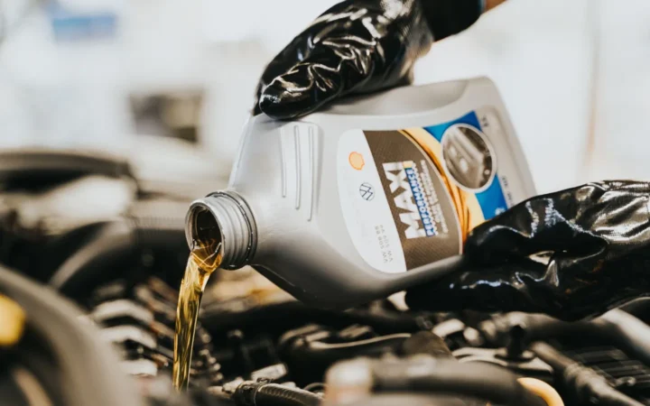 Fresh motor oil being poured into an engine
