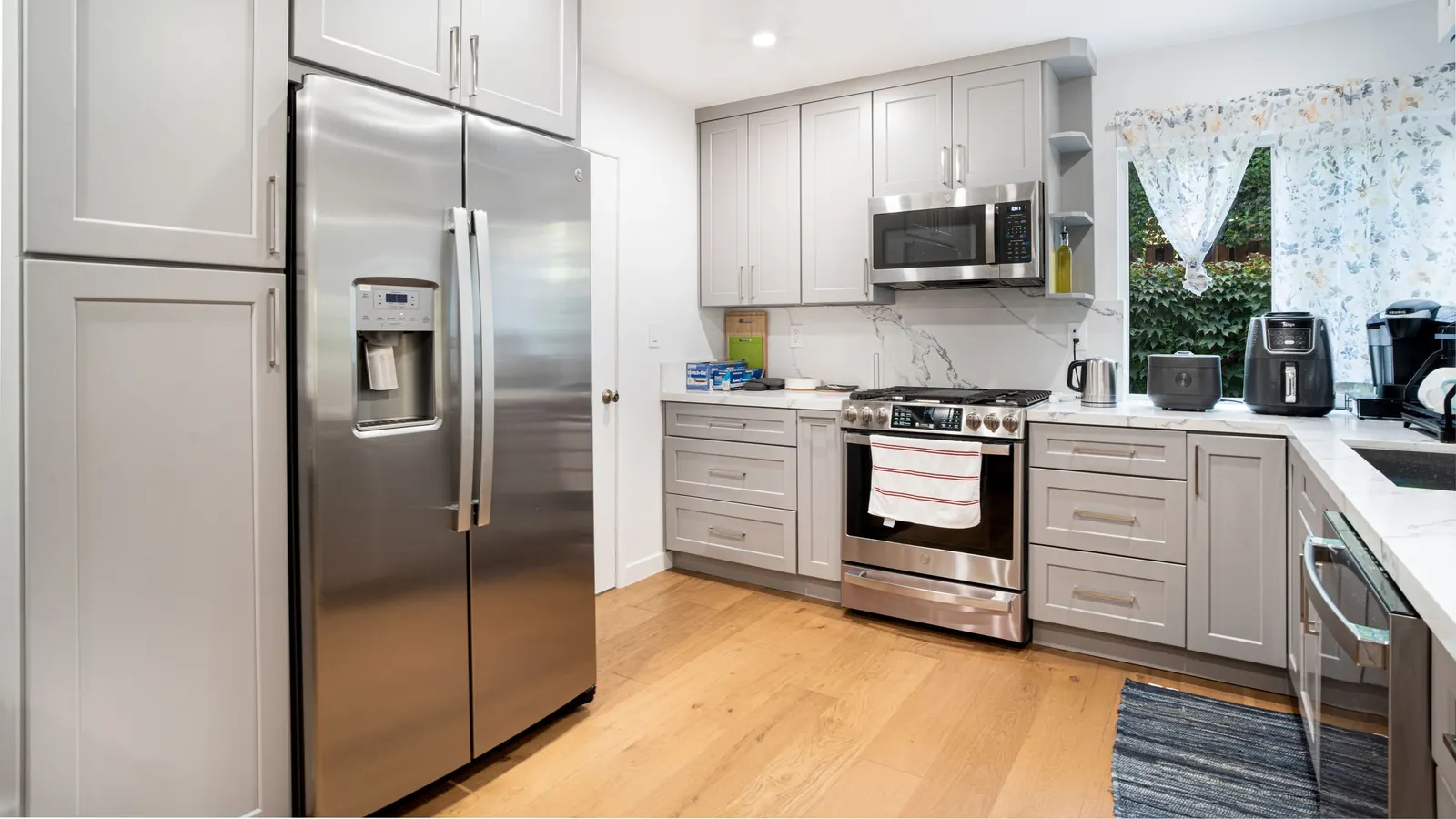 Bright kitchen with a stainless steel refrigerator and range