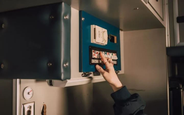 Hand switching a breaker on an electrical panel