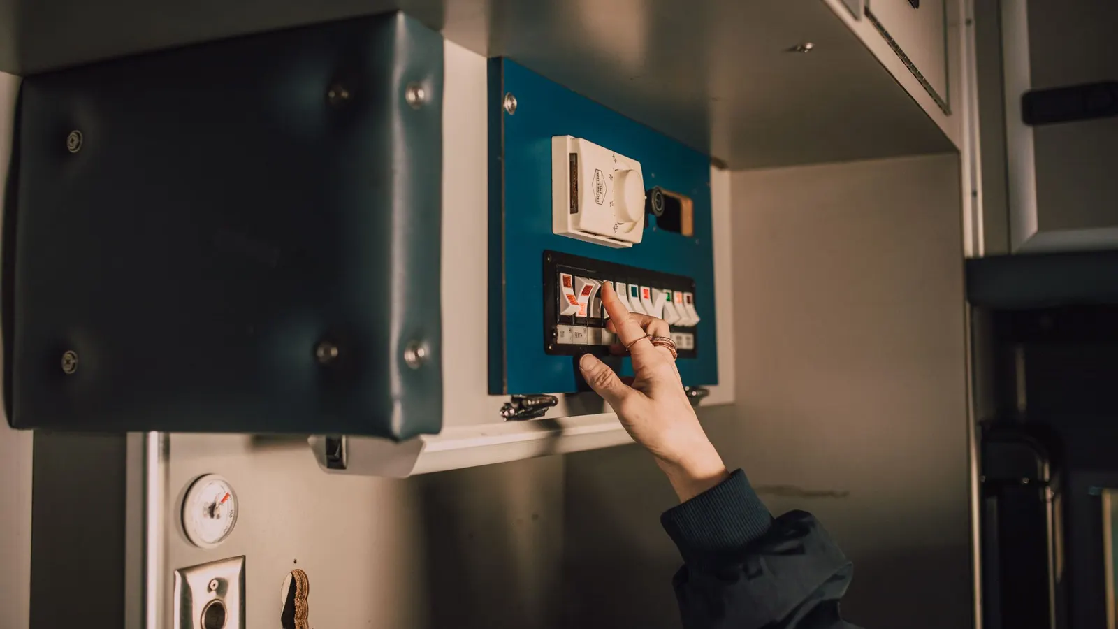 Hand switching a breaker on an electrical panel