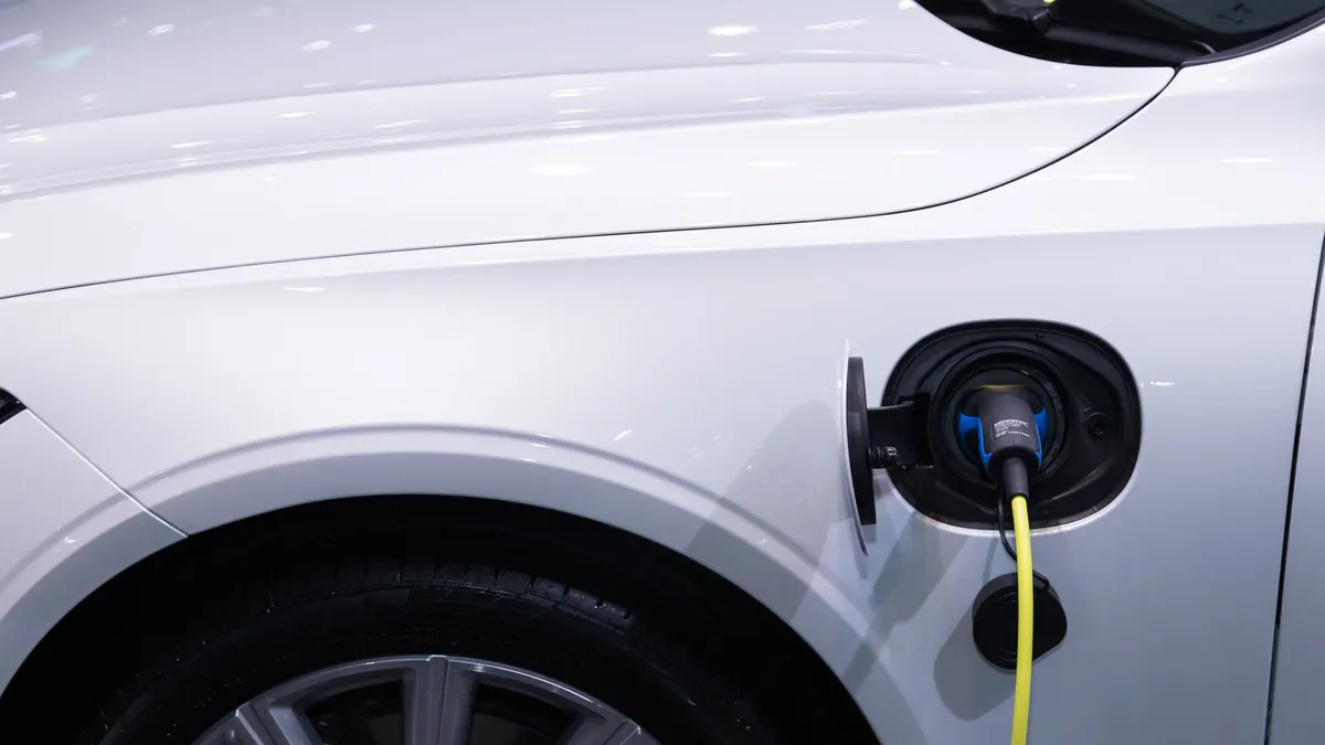 Close-up of a charging cable plugged into an electric car