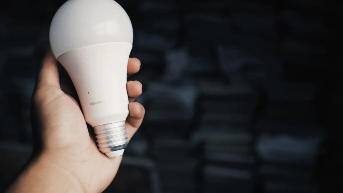 Hand holding an LED light bulb