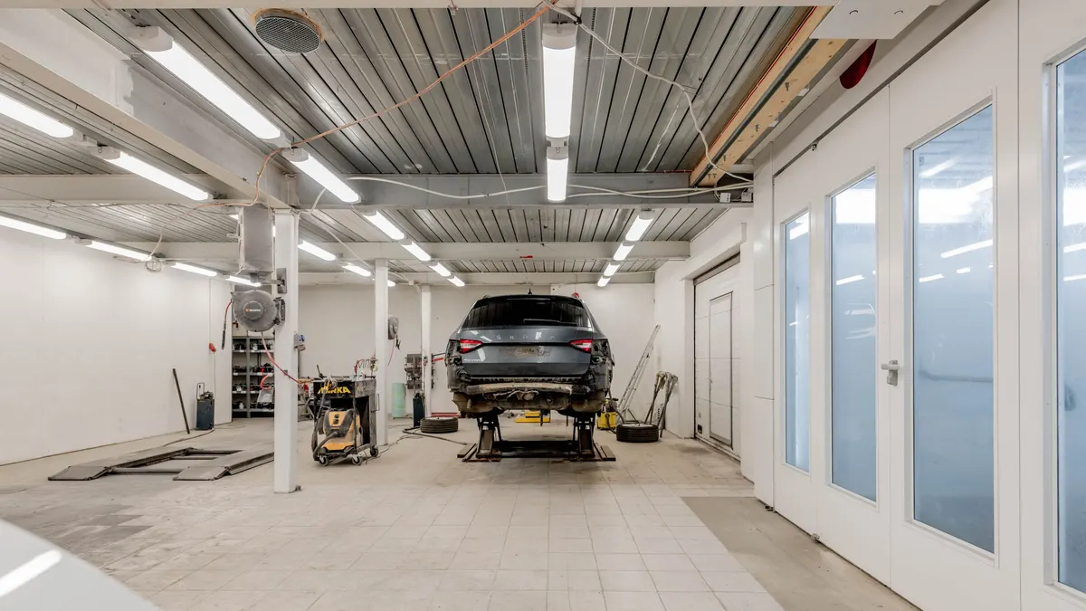 Bright garage workshop with a car on a lift