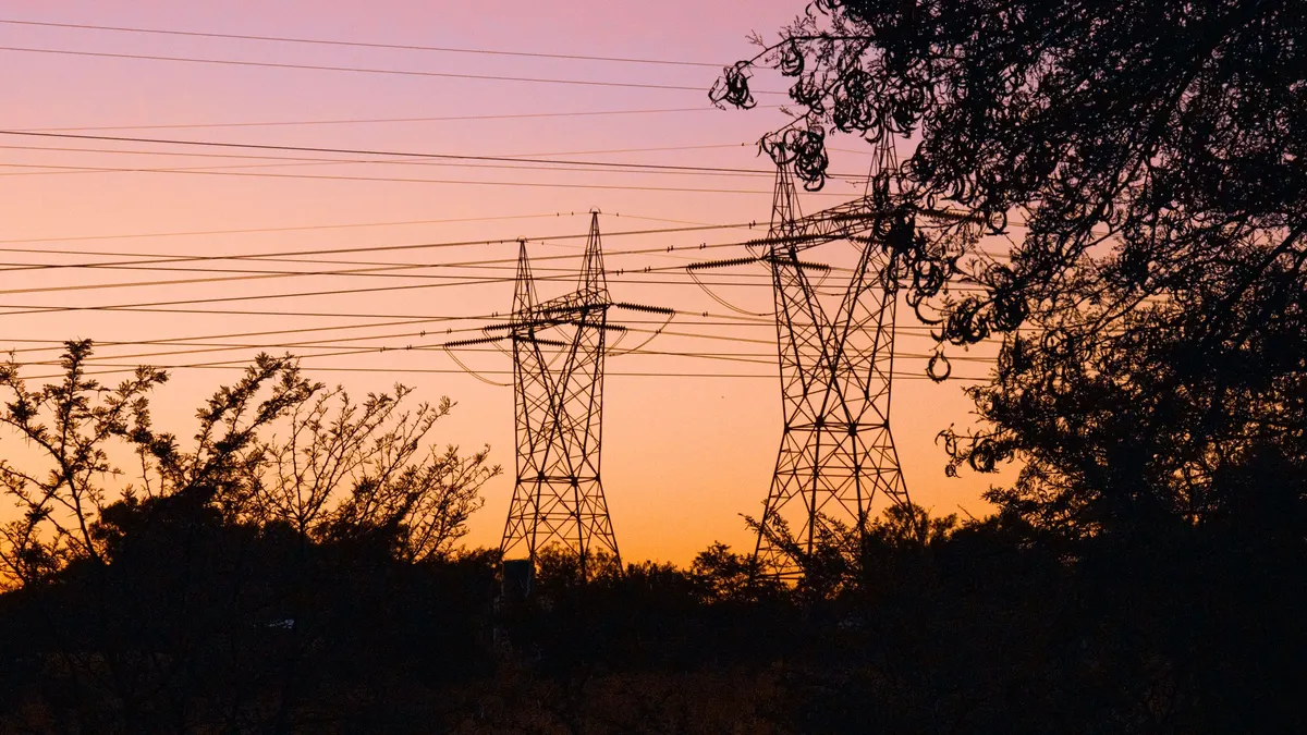 Power lines and transmission towers at sunset