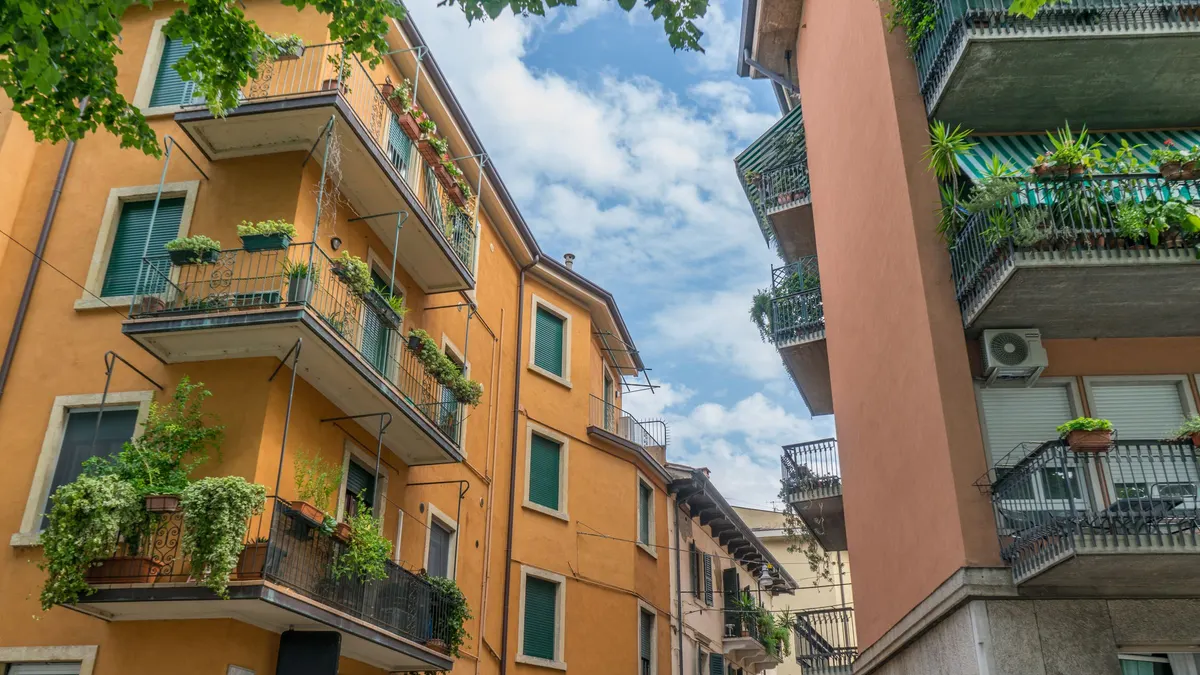 Apartment building with balconies and plants