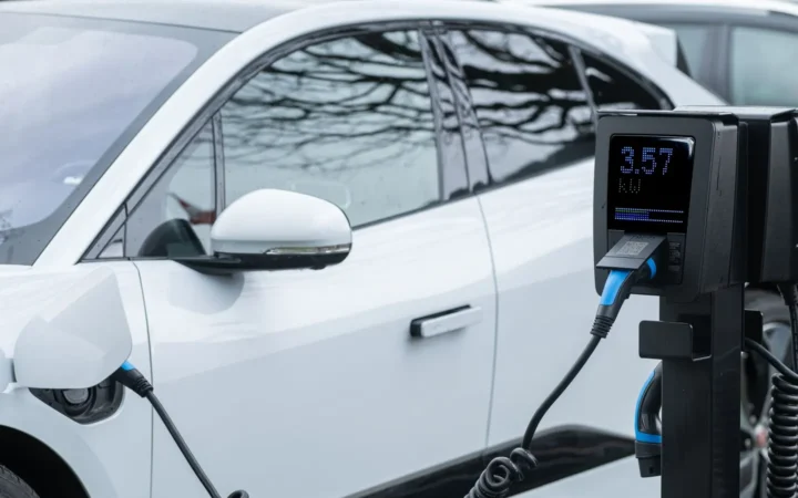 White electric car charging from a pedestal charger