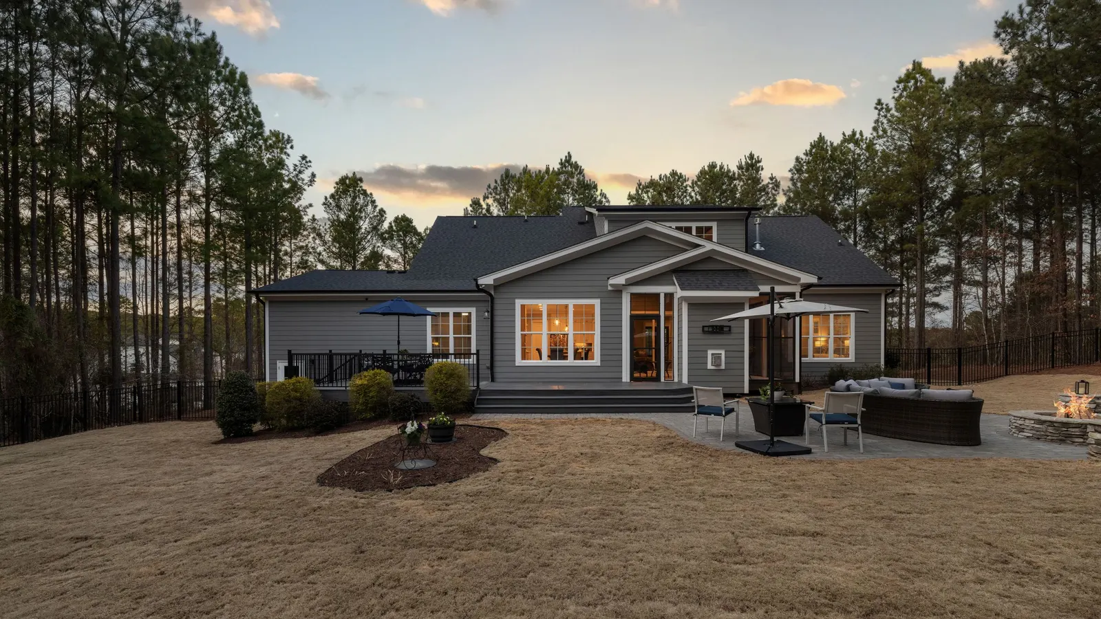 Single-story house with a large yard at sunset