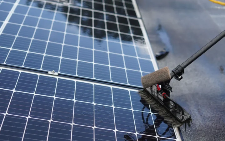 Brush cleaning the surface of a solar panel