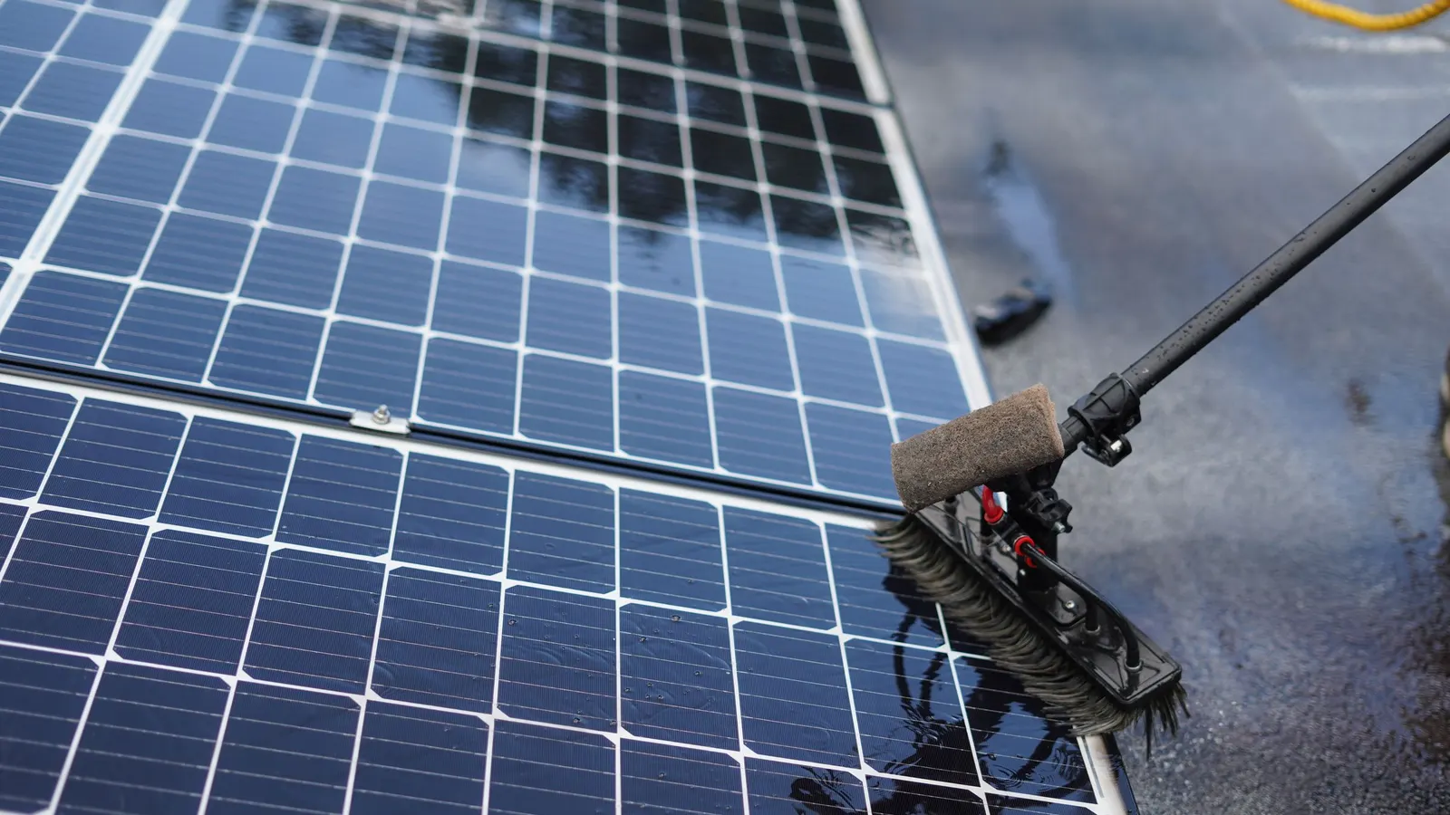 Brush cleaning the surface of a solar panel