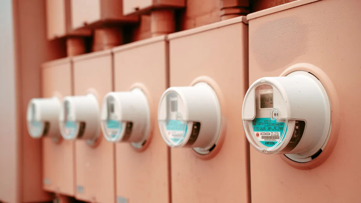 Row of electricity meters on a pink wall