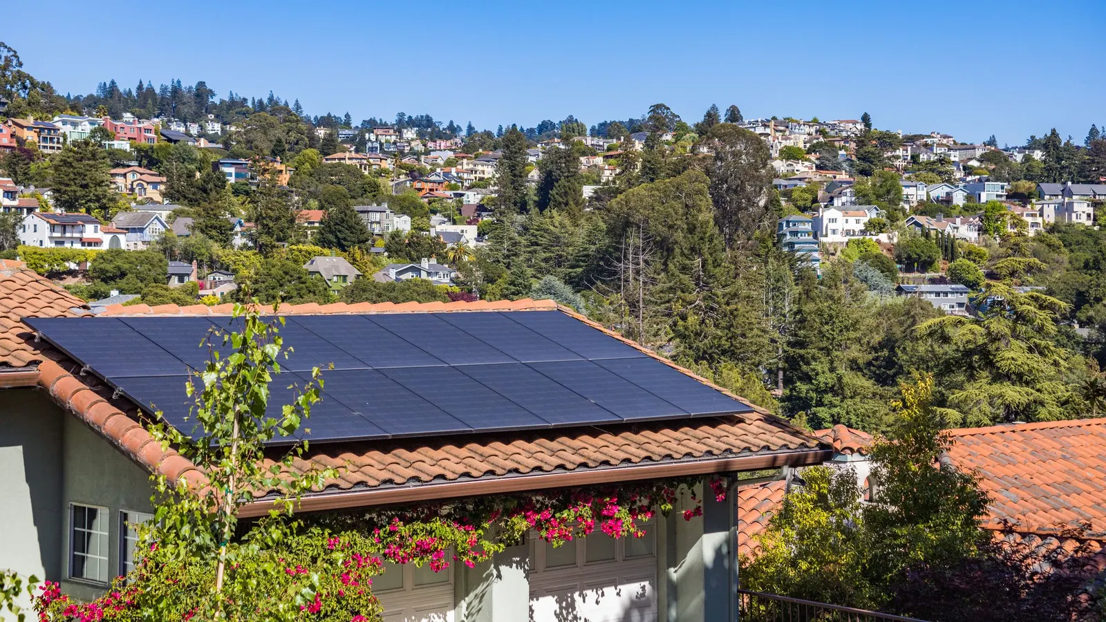 Hillside house with solar panels on a tiled roof
