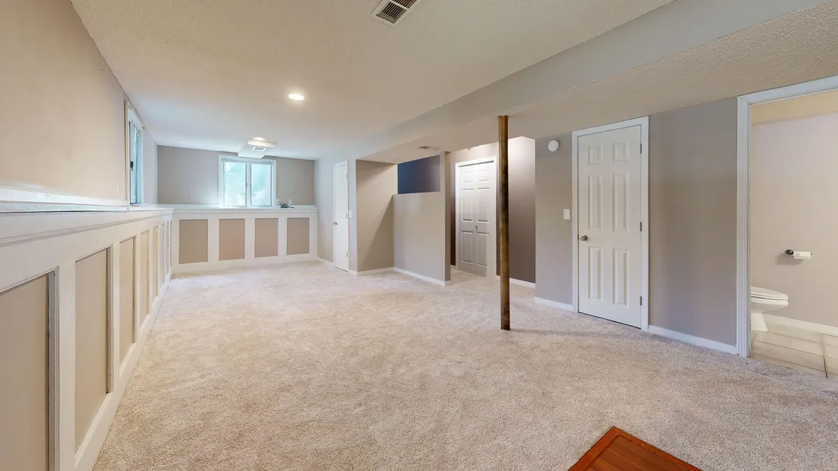 Finished basement with carpet and white trim