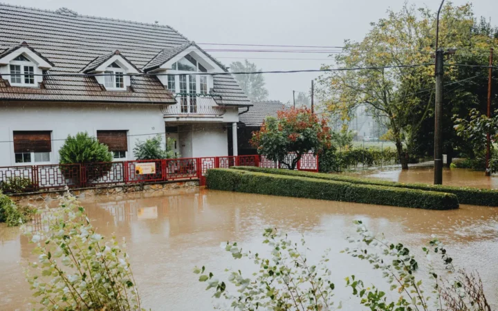 Floodwater covering the front yard of a house