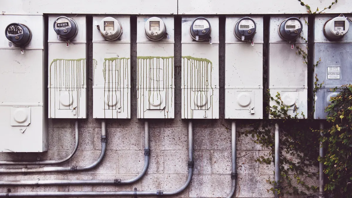 Electrical meters and conduit mounted on a wall