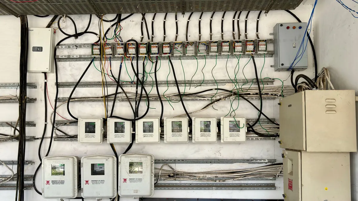 Open electrical panel with rows of circuit breakers and wiring