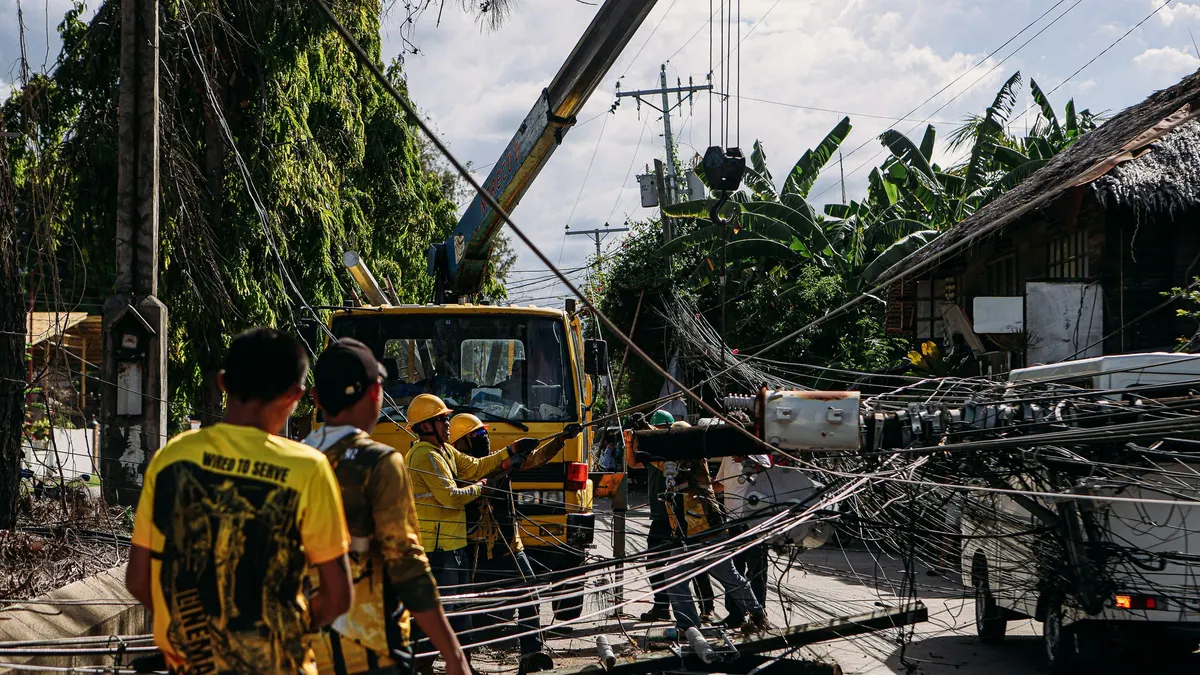 Utility workers repairing downed power lines after a storm
