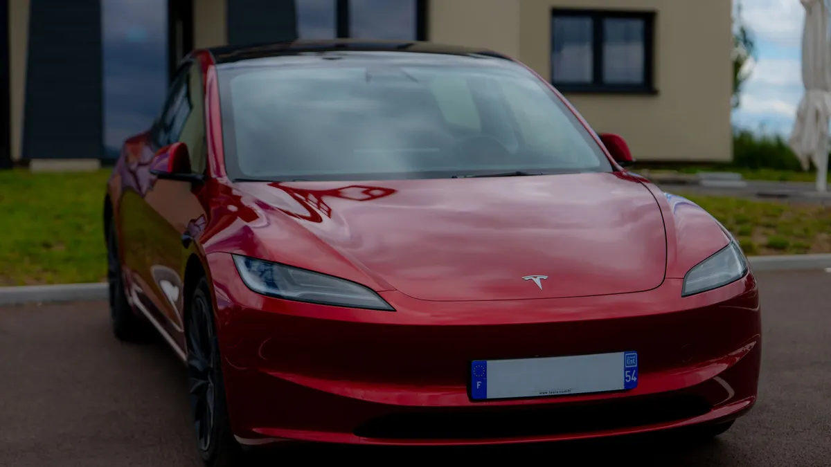 Red electric car parked in a driveway